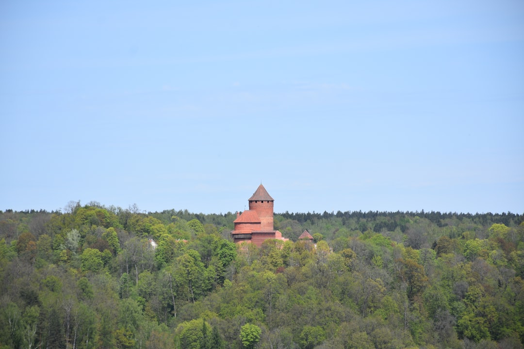 a large building sitting on top of a lush green hillside